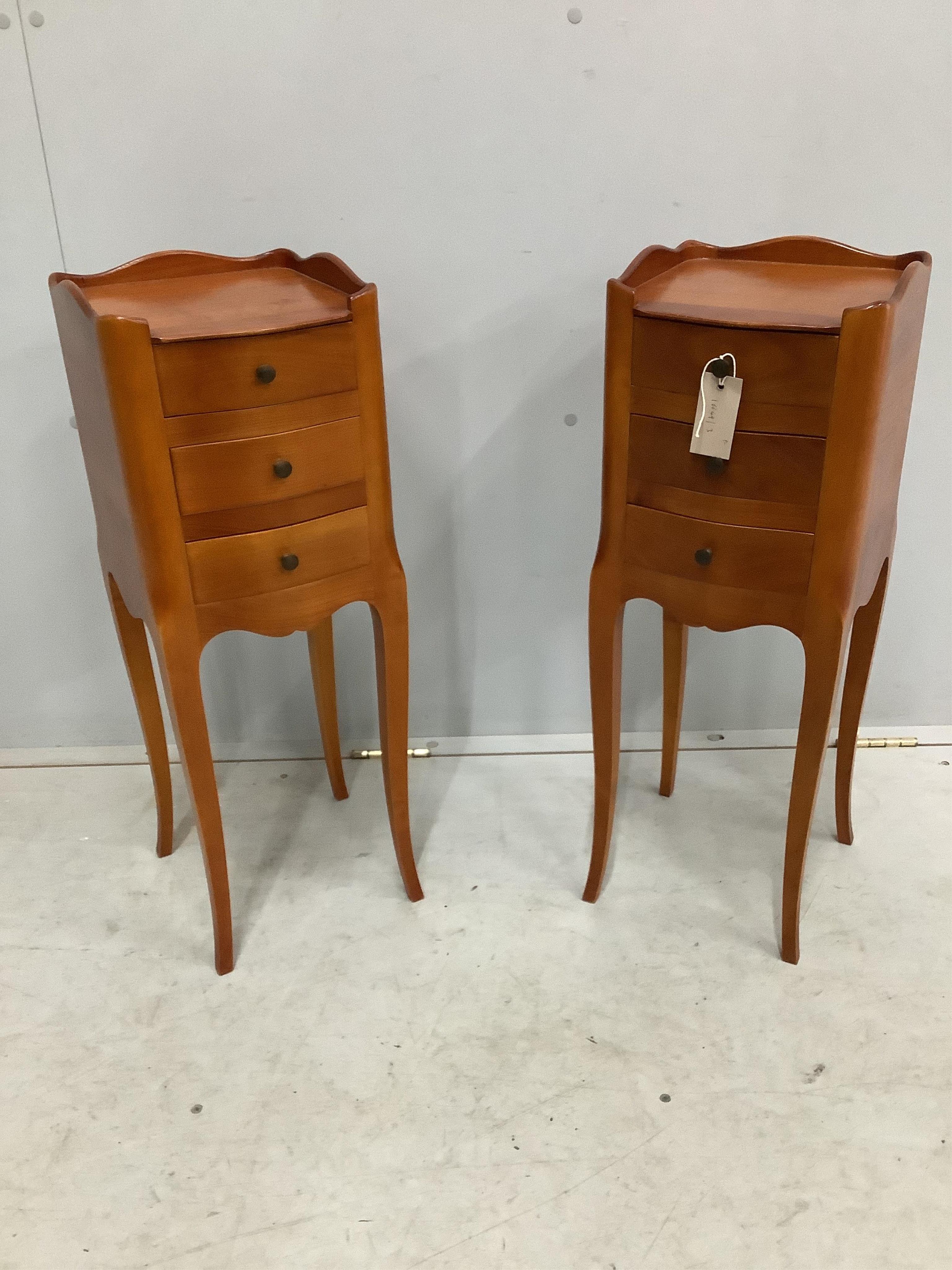 A pair of French cherry three drawer bedside chests, width 24cm, depth 26cm, height 70cm. Condition - fair to good